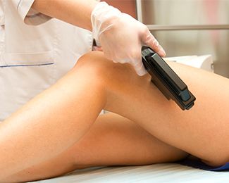 Woman undergoing professional hair removal on her legs